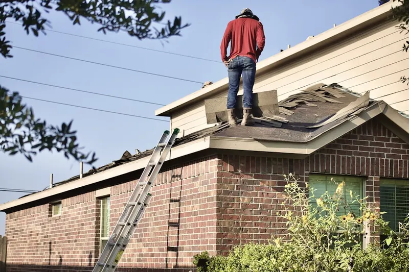 Professional roofer working on a residential roof in Redfield